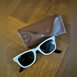 Women’s white vintage Ray Ban wayfarer sunglasses.